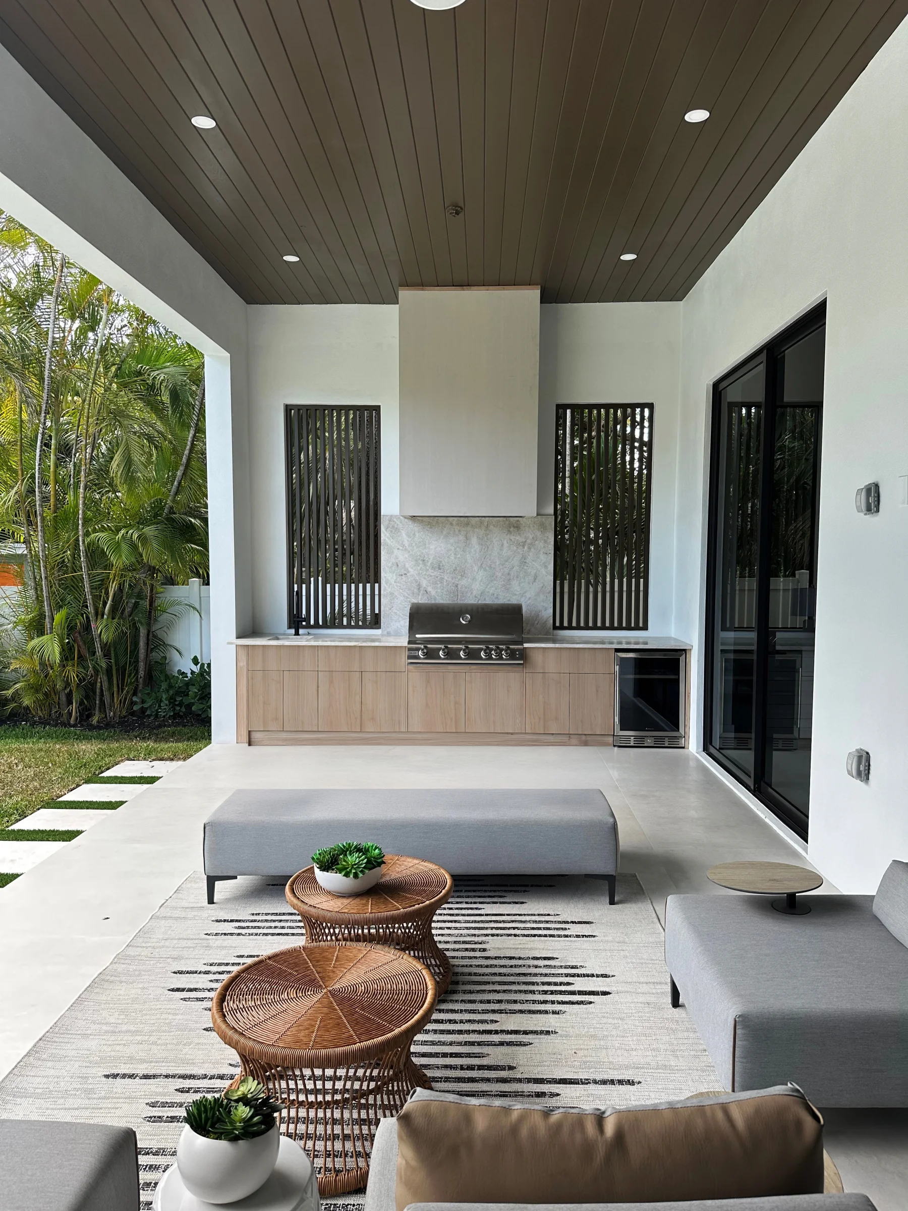 Covered patio outdoor kitchen with LIOHER weatherproof cabinetry, grill and beverage center