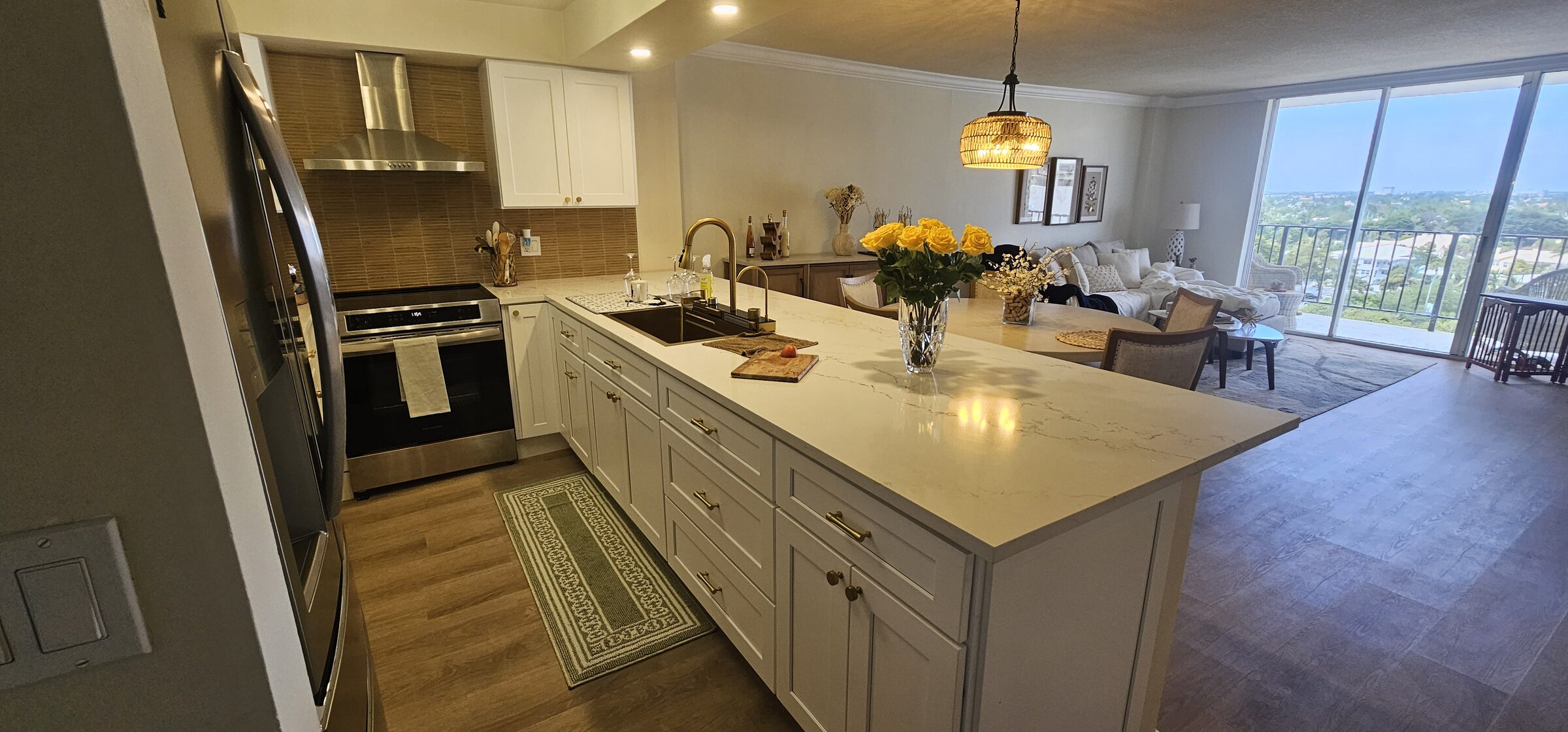 White shaker kitchen remodel with quartz island by Dreamery, South Florida