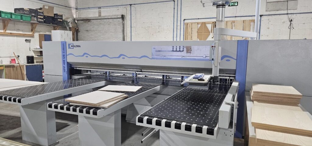 CNC beam saw cutting cabinet panels in the Dreamery shop