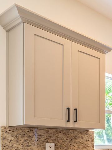 Greige shaker wall cabinet with matte black bar pulls