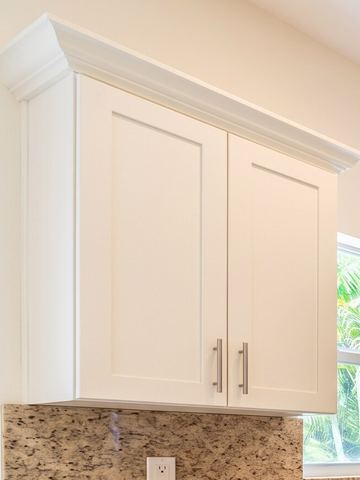 Two-tone shaker wall cabinet with brushed nickel bar pulls