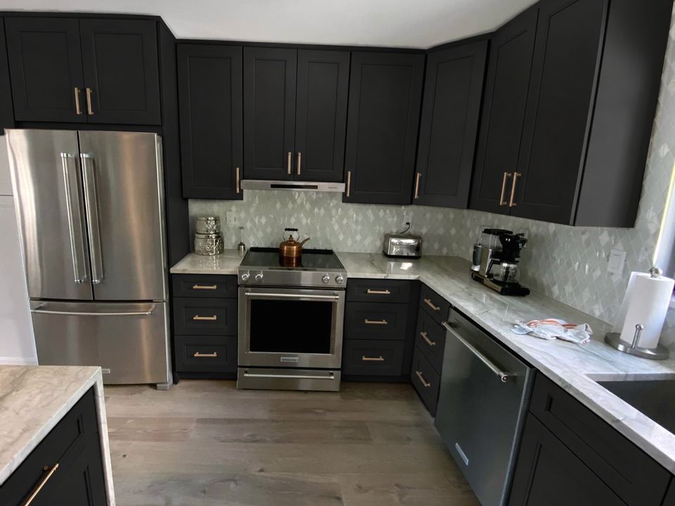 After, visualization: the same kitchen with black shaker cabinets; counters, backsplash and appliances unchanged
